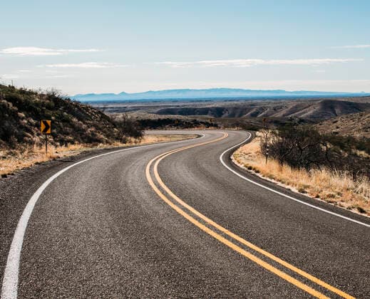 a deserted road winds through the desert near Arrey, New Mexico Arrey, NM, United States CR_SSNF200406E-341594-01