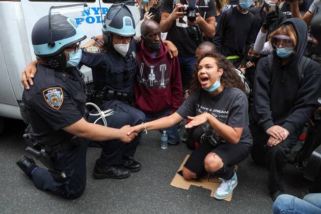 June 2, 2020, New York, New York, United States: A girl after negotiating for long minutes convinced two NYPD officers to kneel along with the other protesters in support of the fight against racism and George Floyd s memory and after hugging each other, she was quite disgusted with the other officers who refused to do the same, and punched the glass of the vehicle that burst, and was immobilized and detained in the Soho neighborhood on Manhattan Island in New York City in the United States on Tuesday night, 02. New York United States - ZUMAv122 20200602_zap_v122_039 Copyright: xWilliamxVolcovx
