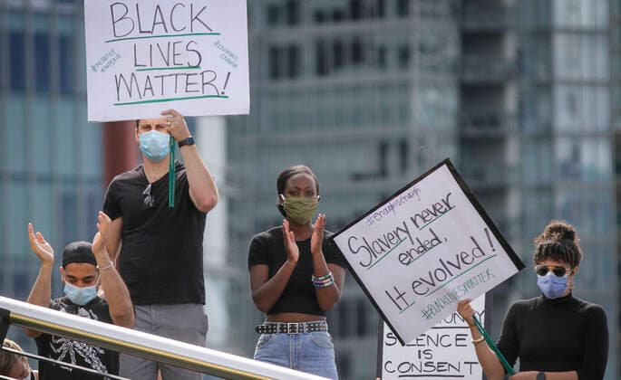 (200606) -- VANCOUVER, June 6, 2020 -- Protestors carry signs during an anti-racism rally over the death of George Floyd at Jack Poole Plaza in Vancouver, Canada, June 5, 2020. (Photo by Xinhua) CANADA-VANCOUVER-ANTI-RACISM RALLY LiangxSen 