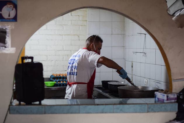 Milton, one of the volunteers at Jesus Pescador de Hombres foundation, in Cali, which prepares and distributes hundreds of daily meals to feed the homeless and Venezuelan migrants during the Coronavirus outbreak in Colombia Cali Colombia Copyright: xNanoxCalvox NN-PESC-COL-3
