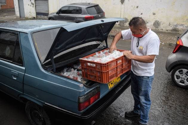 Milton, one of the volunteers at Jesus Pescador de Hombres foundation, in Cali, which prepares and distributes hundreds of daily meals to feed the homeless and Venezuelan migrants during the Coronavirus outbreak in Colombia Cali Colombia Copyright: xNanoxCalvox NN-PESC-COL-27