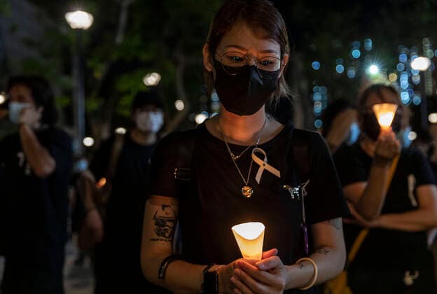 June 15, 2020, Hong Kong, China: Pro-democracy protesters holding up candles to pay respects at a memorial for a man who fell to his death during a protest one year ago at the Pacific Place shopping mall in Hong Kong, China, on Monday, June 15, 2020. Hong Kong authorities and their backers in Beijing have been raising the pressure on opposition politicians with a series of arrests and pointed statements. Several pro-democracy lawmakers have been charged in recent weeks with either joining or inciting people to participate in protests rejected by police Hong Kong China - ZUMAj323 20200615_zip_j323_001 Copyright: xMayxJamesx