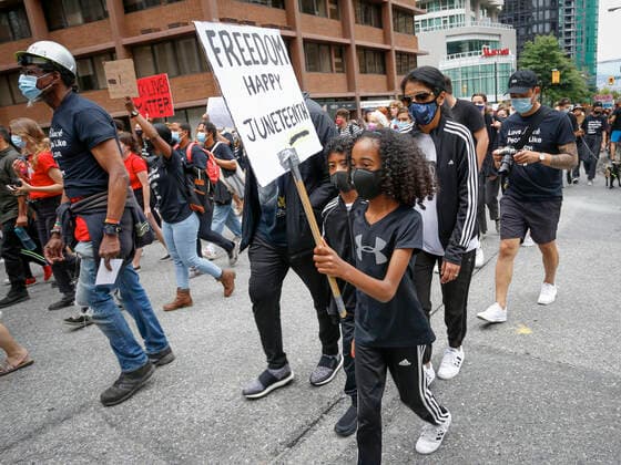 (200620) -- VANCOUVER, June 20, 2020 (Xinhua) -- People holding signs participate in the Juneteenth Freedom March in Vancouver, British Columbia, Canada, June 19, 2020. (Photo by Liang Sen Xinhua) CANADA-VANCOUVER-JUNETEENTH-FREEDOM MARCH 
