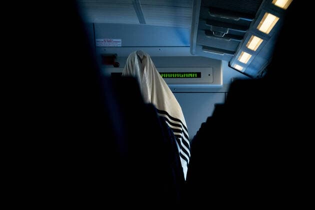 June 22, 2020, Jerusalem, Israel: A Jewish man conducts his morning prayers wrapped in a talit prayer shawl as train service is renewed nationwide after 89 days of Coronavirus suspension. A 500 passengers per train restriction is implied and commuters are required to reserve passage in advance to prevent further spread of COVID-19 as infection rates renew spike in recent weeks. Jerusalem Israel - ZUMAa126 20200622_zap_a126_001 Copyright: xNirxAlonx