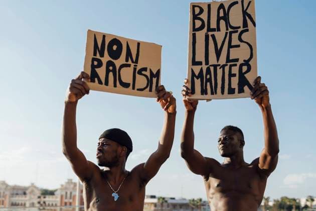 Creative Highlights Symbolfotos Two men holding Black Lives Matter and ati racism signs in the street model released Symbolfoto EGAF00143