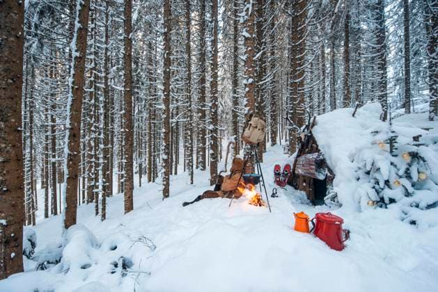 Austria, Salzburg, Altenmarkt-Zauchensee, Small wooden hut and campfire in forest covered with deep snow model released Symbolfoto property released HHF05596