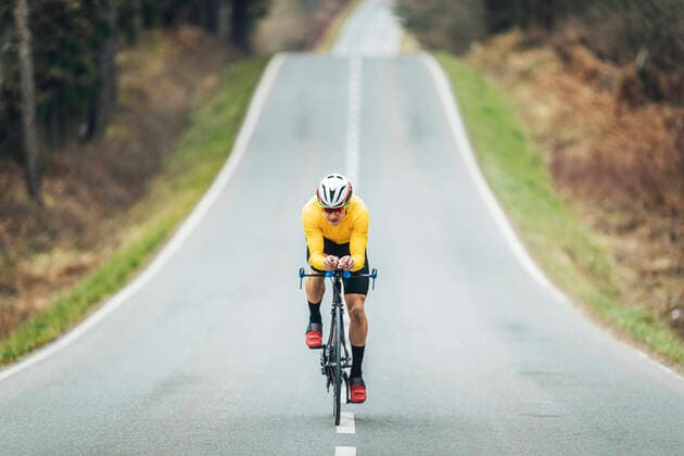 Young sportsperson cycling on road model released Symbolfoto MTBF00394