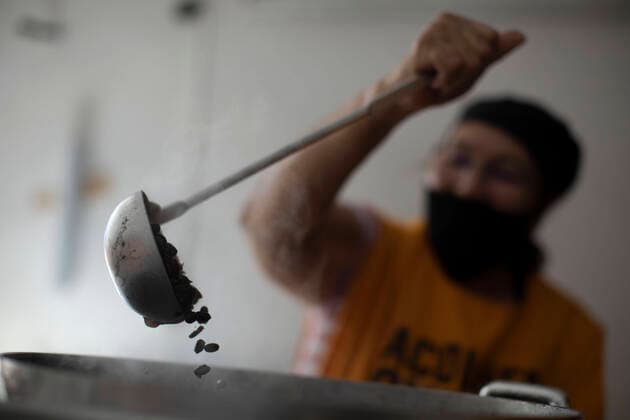 June 23, 2020, Rio De Janeiro, Rio de Janeiro, Brazil: Volunteers works on preparation and delivery on a Franciscan Action to donate meals to the homeless and unemployed in Largo da Carioca, in downtown Rio de Janeiro, amid the increasing impacts of the new coronavirus pandemic. The action, carried out by volunteers and the friars of the Franciscan Solidarity Service (Sefras), in partnership with the Santo AntoÂ nio Convent and the SoÂ£o BonifoÂ¡cio Parish , from Germany, has already donated more than 10,000 meals in 20 days, delivering an average 450 daily meals, between lunch and dinner. Rio De Janeiro Brazil - ZUMAs255 20200623_zip_s255_025 Copyright: xFernandoxSouzax