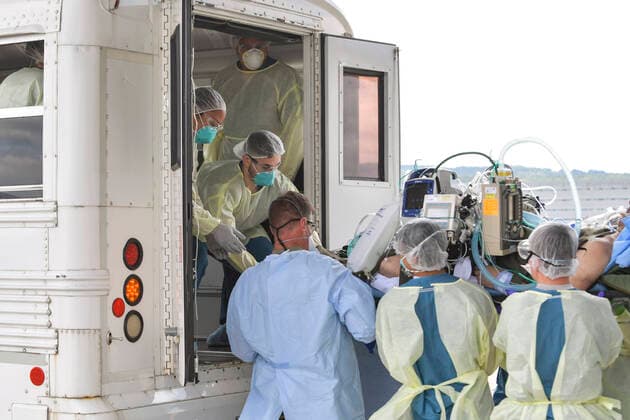 July 1, 2020 - Ramstein Air Base, Rheinland-Pfalz, Germany - Airmen assigned to the 86th Medical Group and 313th Expeditionary Operations Support Squadron transfer a COVID-19 patient following the first-ever operational use of the Negatively Pressurized Conex to transport 12 patients aboard a C-17 Globemaster III aircraft at Ramstein Air Base, Germany, July 1, to receive higher level of care at the Landstuhl Regional Medical Center, Germany. The NPC is the latest isolated containment chamber developed to transport up to 28 individuals with infectious diseases. Ramstein Air Base Germany - ZUMAz03_ 20200701_sha_z03_633 Copyright: xU.S.xAirxForcex