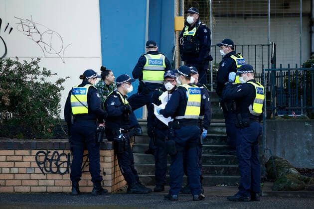 MELBOURNE COVID-19 PUBLIC HOUSING LOCKDOWN, A woman (second left) is questioned by police after attempting to flee in her car, outside public housing towers on Racecourse Road in Flemington, Melbourne, Sunday, July 5, 2020. Police are enforcing a lockdown at public housing towers in Melbourne after Victoria recorded 108 new coronavirus cases, forcing the lockdown of nine public housing towers and two more Melbourne postcodes. ( NO ARCHIVING, EDITORIAL USE ONLY, NO USE IN BOOKS WITHOUT CONSENT MELBOURNE VICTORIA AUSTRALIA  Copyright: xDANIELxPOCKETTx 20200705001478089758