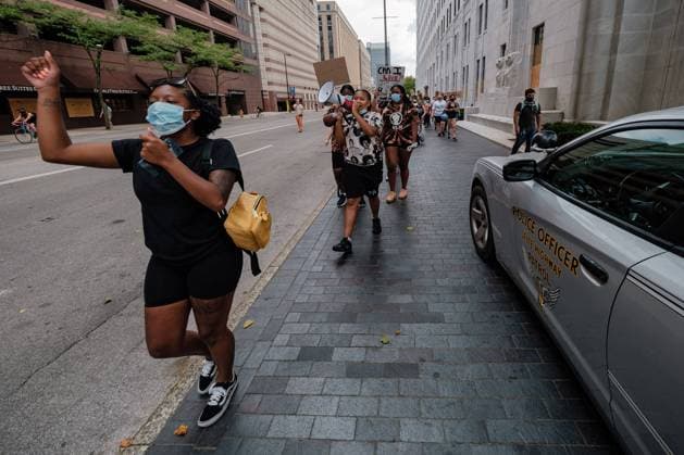 July 4, 2020, Columbus, Ohio, USA: Protestors pass an Ohio Highway Patrol cruiser during a Black Lives Matter protest, and Violin vigil held in honor of Elijah McClain, Saturday, July 4 at City Hall in Columbus, Ohio. Columbus USA - ZUMAd160 20200704_znp_d160_003 Copyright: xAndrewxDolphx