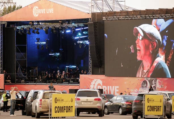 MOSCOW REGION, RUSSIA - JULY 4, 2020: Singer song writer Garik Sukachov performs in a drive-in concert in Yakhroma Park in the town of Dmitrov, Moscow Region. The concert, in which the sound is broadcast to the cars via FM radio, is part of LIVE&DRIVE, a series of live drive-in concerts organised by the TCI concert agency and SAV Entertainment Group during the pandemic of the novel coronavirus disease (COVID-19). Mikhail Metzel TASS  TS0DF241