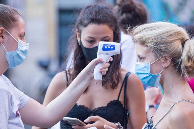 Italy: Il Cinema in Piazza in Rome Boys of Piccolo America association measure the body temperature of the people who have booked the place Roma RM Italy Copyright: MatteoxNardone