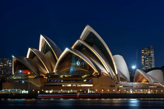 Opera House and city CBD at sunset. Illuminated arch of the bridge reflecting in blurred waters Sydney, New South Wales, Australia Sydney New South Wales Australia Copyright: xSergixReboredox SRE-098-EJ5404