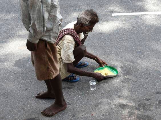 July 8, 2020, Guwahati, Assam, India: A needy man takes food from volunteer, during lockdown to curb the spread of the novel coronavirus, in Guwahati. Guwahati India - ZUMAt232 20200708_zip_t232_011 Copyright: xDavidxTalukdarx