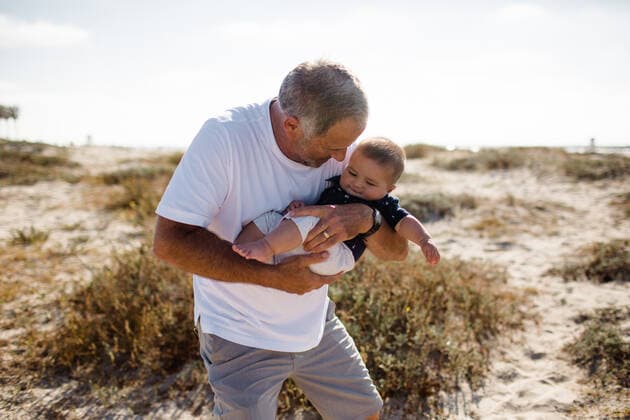 Grandfather Cradling Grandson While Standing on Beach San Diego, CA, United States CR_JIDE200701-431392-01 ,model released, Symbolfoto