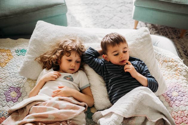 IMAGO Creative, Weihnachten, Tradition: Weihnachtsfilme sehen Brother and sister laying in livingroom together watching movie Fort Worth, TX, United States CR_TAHI200701-413964-01 ,model released, Symbolfoto