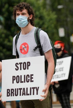 (200711) -- VANCOUVER, July 11, 2020 -- A protester participates in the anti police brutality rally in Vancouver, British Columbia, Canada, July 11, 2020. Thousands of people in several cities in British Columbia took part in the anti police brutality rally on Saturday. (Photo by Xinhua) CANADA-VANCOUVER-ANTI POLICE BRUTALITY-PROTEST LiangxSen 