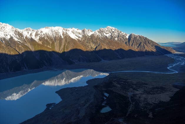 (200714) -- QUEENSTOWN, July 14, 2020 -- Photo taken on July 13, 2020 shows Tasman Lake near the Tasman Glacier at Aoraki Mount Cook National Park in the South Island of New Zealand. The Aoraki Mount Cook National Park consists of 19 peaks which are at least 3000 meters above sea level, as well as the Tasman Glacier and many glacial lakes. ) NEW ZEALAND-SOUTH ISLAND-AORAKI MOUNT COOK NATIONAL PARK GuoxLei 