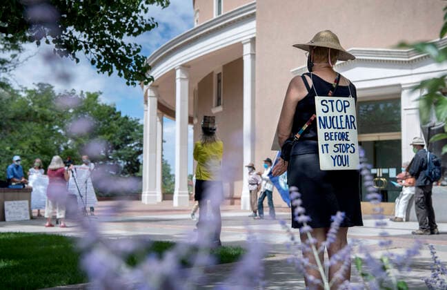 July 16, 2020, USA: Chrysa Wikstrom, from Santa Fe, joins around 25 people for a socially distanced, face mask wearing protest of nuclear weapons outside the Roundhouse in Santa Fe, Thursday July 16, 2020. The protest led by the Los Almaos Study Group was protesting against nuclear weapons on the 75th anniversary of the first test of an atomic bomb built at Los Alamos and detonated at the Trinity Site near Alamogordo in 1945. USA - ZUMAab1_ 20200716_zaf_ab1_006 Copyright: xEddiexMoorex