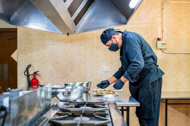Chef preparing salad on plate model released Symbolfoto property released DLTSF00835