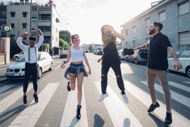 Group of carefree friends jumping on a street in the city model released Symbolfoto MEUF00785