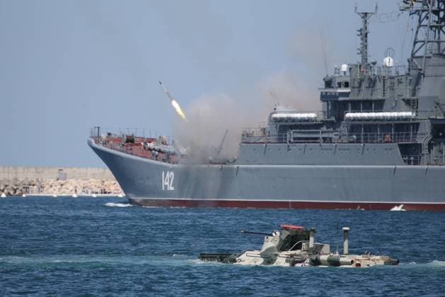 SEVASTOPOL, RUSSIA - JULY 24, 2020: The Novocherkassk landing ship (back) and a BTR-82 armoured personnel carrier take part in the dress rehearsal of a naval parade marking Russian Navy Day. Sergei Malgavko TASS  TS0E1069