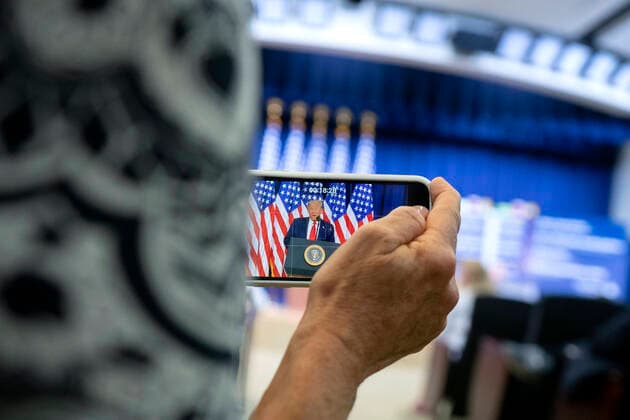 July 24, 2020, Washington, District of Columbia, USA: An attendee records United States President Donald J. Trump on her phone as he speaks during an executive order signing ceremony on lowering drug prices in the Eisenhower Executive Office Building in Washington, D.C., U.S., on Friday, July 24, 2020. Lowering prescription drug prices is a top priority of Trump including a policy to tie Medicare payments to foreign countries drug prices Washington USA - ZUMAs152 20200724_zaa_s152_083 Copyright: xStefanixReynoldsx