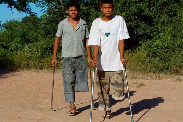 Youngsters who lost legs in landmine blasts walk on crutches at a rehabilitation centre in Siem Reap Cambodia ÂxCOPYRIGHTxAndrewxWoodley 4044_04_mine07_a46a3121