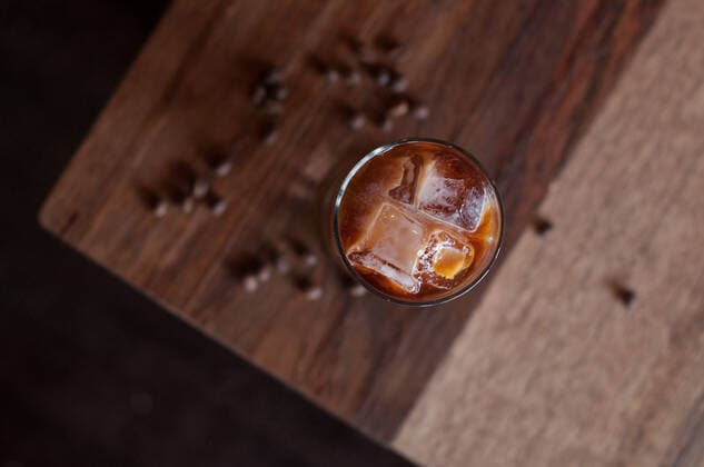 Tall Glass of cold brew iced coffee on a wooden coffee table Phoenix, AZ, United States CR_ELBA200705-444160-01