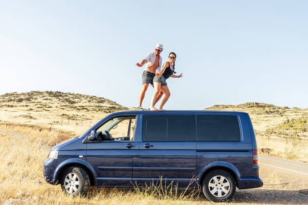 happy couple surfing on top of the van. Badajoz, EX, Spain CR_MIPA200724-459069-01 ,model released, Symbolfoto