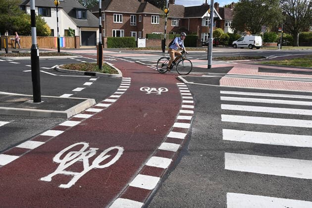 Cambridge, UK - 6 August 2020 UK s first Dutch-style roundabout in Cambridge near Addenbrooke s Hospital that gives priority to bicycles. Cambridgeshire County Council s £2.3million project gives cyclists an outer ring on the roundabout, with cycle crossings over each of the four approach roads in a contrasting red surface, and motorists must give way to pedestrians and cyclists when joining and leaving the roundabout. . 06 08 2020. London, United Kingdom. Britain s first Dutch-style roundabout in Cambridge.  xNilsxJorgensenx xi-Imagesx IIM-21512-0024