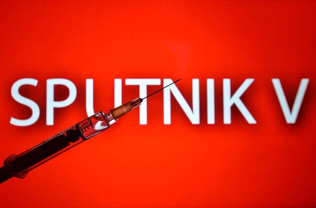 August 11, 2020, Krakow, Lesser Poland Voivodeship, Poland: In this photo illustration a medical syringe and Sputnik V inscription in the background. Krakow Poland - ZUMAs197 20200811_zab_s197_043 Copyright: xCezaryxKowalskix