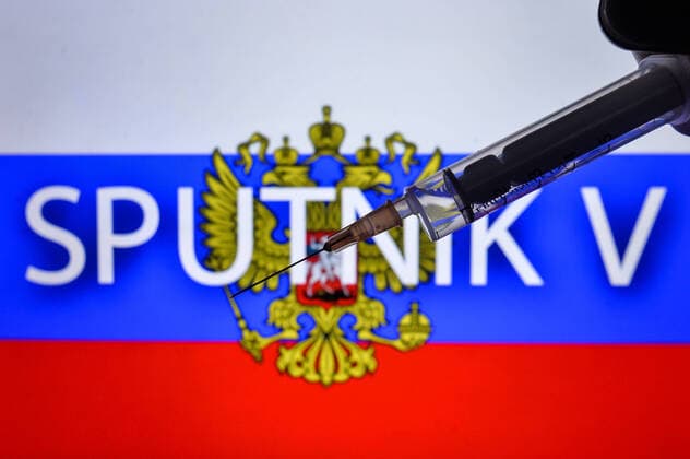 August 11, 2020, Krakow, Lesser Poland Voivodeship, Poland: In this photo illustration a medical syringe and Russian flag with Sputnik V inscription in the background. Krakow Poland - ZUMAs197 20200811_zab_s197_048 Copyright: xCezaryxKowalskix