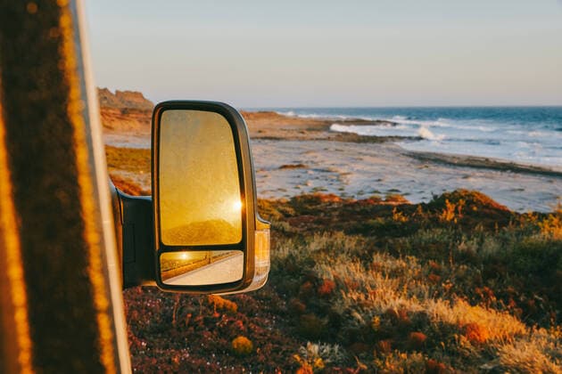 Sunset reflected in side mirror of camper van in Baja, Mexico. Baja California, Chis., Mexico CR_JUSLKY200806-466777-01 ,property released