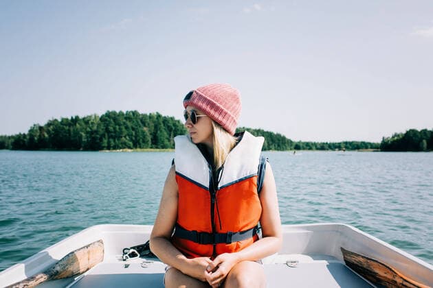 woman sitting peacefully on a rowing boat in summer on a lake Norrtälje, Stockholm County, Sweden CR_RABE200812-471629-01 ,model released, Symbolfoto