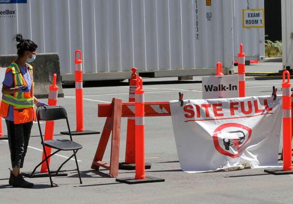 (200814) -- VANCOUVER, Aug. 14, 2020 -- A Site Full poster is displayed in front of a COVID-19 testing facility in Vancouver, British Columbia, Canada, on Aug. 14, 2020. British Columbia s COVID-19 curve is now climbing at a higher rate than the initial outbreak in March, and new provincial modelling shows B.C. could see a second wave bigger than the first by September. (Photo by Xinhua) CANADA-VANCOUVER-COVID-19-TEST LiangxSen 
