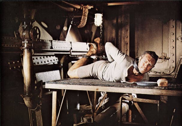 PAPILLON STEVE McQUEEN Date: 1973. Strictly editorial use only in conjunction with the promotion of the film. Credit line mandatory. This image is copyright of the film company and is supplied under the terms of issue as film still. No commercial or book cover use permitted without prior consent from the film company.  Mandatory credit line: Image courtesy Ronald Grant Archive Mary Evans