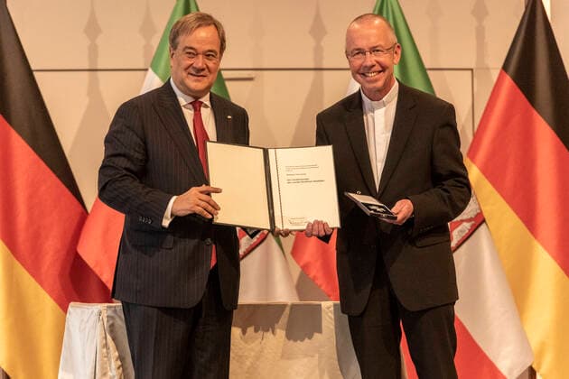 Verleihung des Landesverdienstordens Nordrhein-Westfalen am 23. August 2020 in der Flora Köln. Ordensträger Monsignore Peter Kossen erhält von NRW-Ministerpräsident den Orden überreicht. Kossen kämpft seit Jahren gegen menschenunwürdige Arbeitsbedingungen für Menschenwürde und Gerechtigkeit. Laschet zeichnete am 23. August 2020 in der Flora in Köln vierzehn Persönlichkeiten für ihr außerordentliches Engagement für die Gesellschaft mit dem Verdienstorden des Landes Nordrhein-Westfalen aus. Köln Nordrhein-Westfalen Deutschland