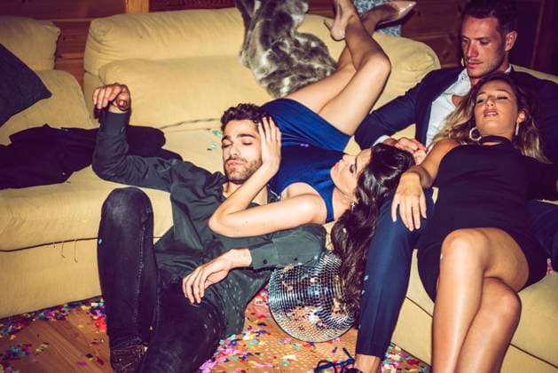 Tired male and female friends resting on sofa in party model released Symbolfoto property released EHF00687