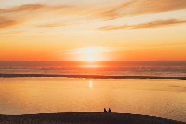 Silhouette couple watching sunset at Atlantic ocean, Dune of Pilat, Nouvelle-Aquitaine, France GWF06638