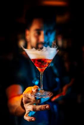 Close-up of male bartender holding cocktail in nightclub model released Symbolfoto OCMF01576