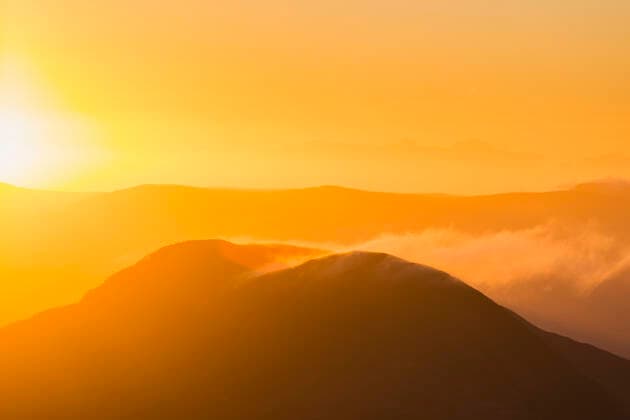 Silhouette of a hill in Kerry at sunrise with snow being blown off the top, MacGillycuddy s Reeks; County Kerry, Ireland  Copyright: MichealxHoward 13492113