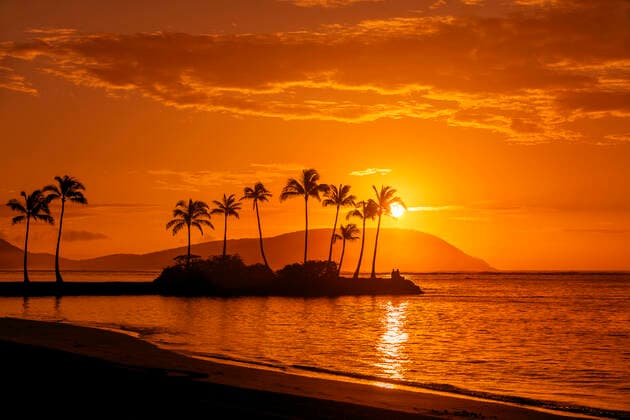Sunrise at Kahala Beach, WaiÊ»alae Beach Park, with a flare around the sun in a glowing red sky reflected in the tranquil water; Oahu, Hawaii, United States of America  Copyright: 770xProductions 13612800