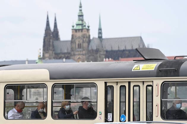 Passengers with protective face masks pass by a tram through the center of Prague, Czech Republic, on September 1, 2020. In the background of the photo is seen Prague castle. (CTKxPhoto MichalxKamaryt) CTKPhotoP202009010552901 kmt 1