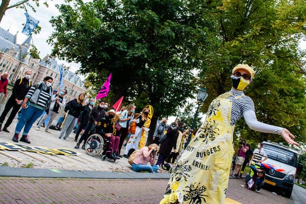 September 1, 2020, The Hague, South Holland, Netherlands: The XR fashion designer posing with her XR design during the fashion show..An XR fashion show was carried out in front of the House of Representatives in The Hague. Models wore yellow, black, and white colourful second-hand outfits to symbolise the collectivity of bees, to show that thinking and working together can help us out of this crisis. The Hague Netherlands - ZUMAs197 20200901_zaa_s197_024 Copyright: xAnaxFernandezx