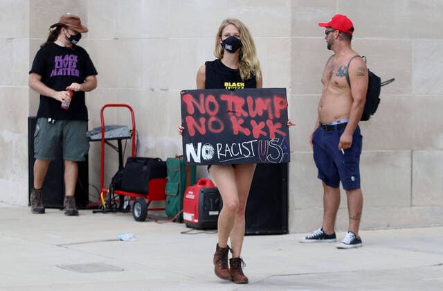 September 2, 2020, Wilmington, North Carolina, USA: A Black Lives Matter advocates walks past a Donald Trump supporter as they protest the visit of President Donald Trump to Wilmington, NC. On Wednesday Trump declared the city an American World War II Heritage City, making it the first in the country. The president was expected to meet with veterans, tour the Battleship North Carolina and speak about WilmingtonÃ¢â‚¬â ¢s part in World War II. This was the PresidentÃ¢â‚¬â ¢s 12th visit to North Carolina. Wilmington USA - ZUMAk251 20200902_znp_k251_005 Copyright: xBobxKarpx