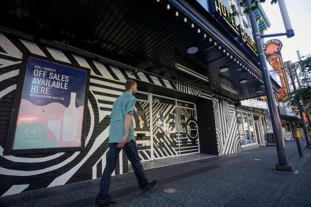 (200910) -- VANCOUVER, Sept. 10, 2020 -- A man walks past a nightclub at Granville street in Vancouver, British Columbia, Canada, Sep 9, 2020. As more evidence found nightclubs and bars are the sources led to the rebound of COVID-19 cases in Vancouver, health authority ordered to close all nightclubs and banquet halls immediately. (Photo by Xinhua) CANADA-VANCOUVER-COVID-19-MEASURE LiangxSen 