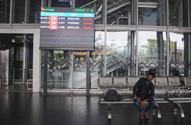 India: Weekly lockdown in Kolkata Passengers wait at deserted NSCBI Airport during a weekly lock down amid concern for COVID 19 pandemic. Kolkata West Bengal India Copyright: VedxPrakash