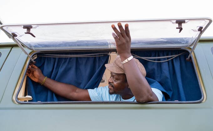 black african american man in the window of his camper van Valderrobres, Aragon, Spain CR_HERO200910B-499889-01 ,model released, Symbolfoto